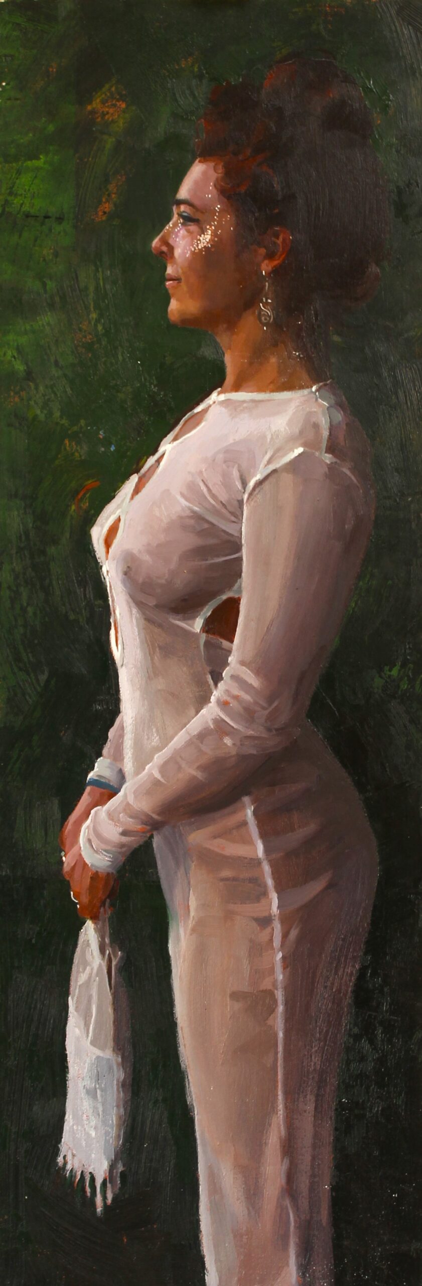 woman standing in profile holding a bag